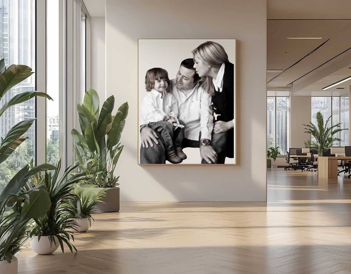 Black and white portrait of a mother, father and kid, displayed as wall art in a modern living room, representing a timeless family photo session.